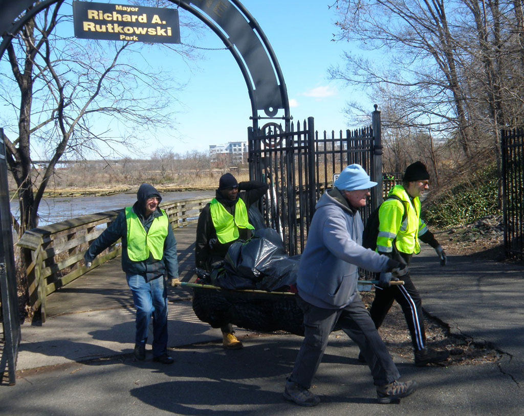Collected trash being brought in after cleanup.