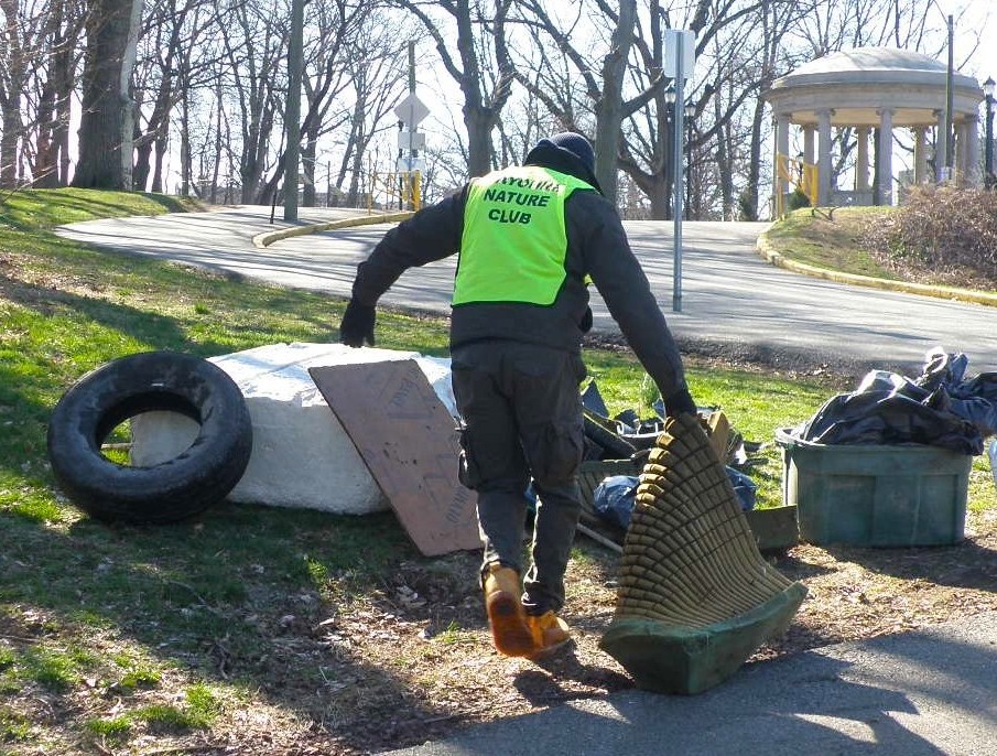 Trash pickup in progress during shoreline cleanup.